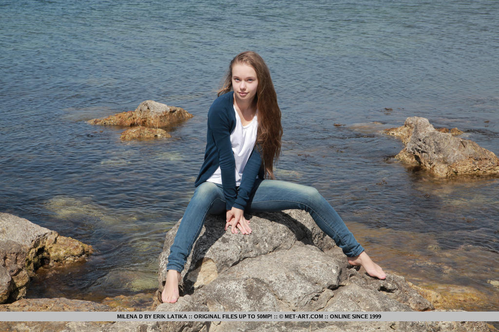 Milena looks delicately sweet and   sexy, wearing a silver cardigan and   her angelic, youthful appeal as she   plays and have fun at the rocky beach.