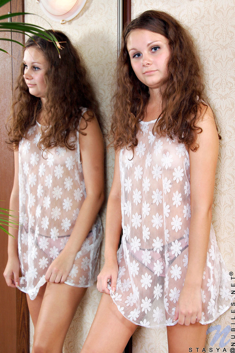 Curly haired teen Stasya unveils her tan lines on her cute tits and shaved pussy