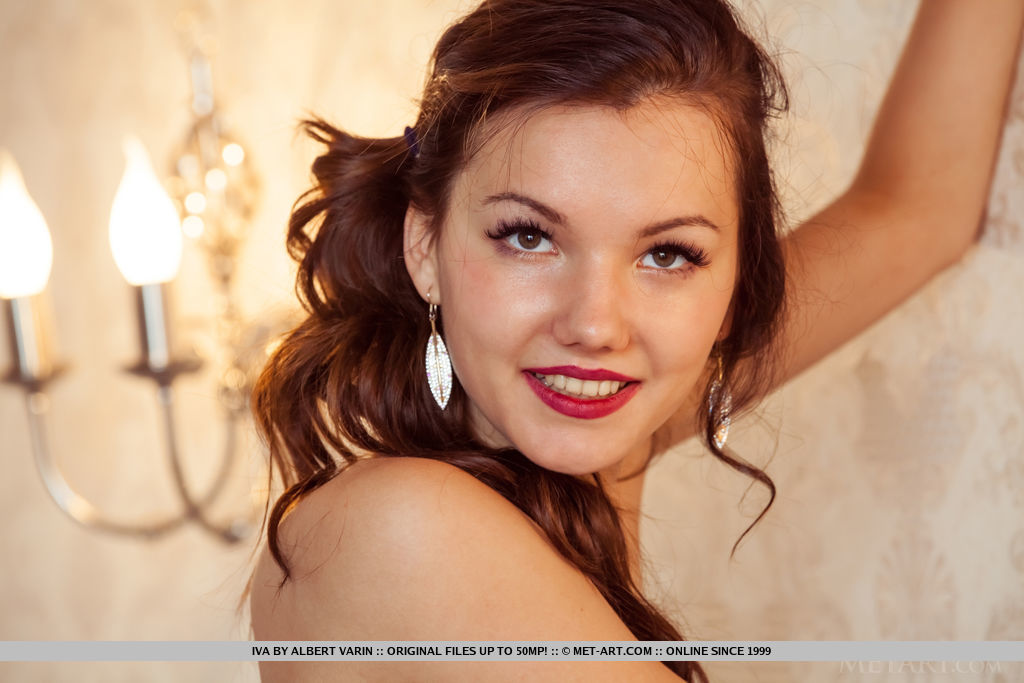 Iva sensually poses on the bed as she bares her hairy pussy.