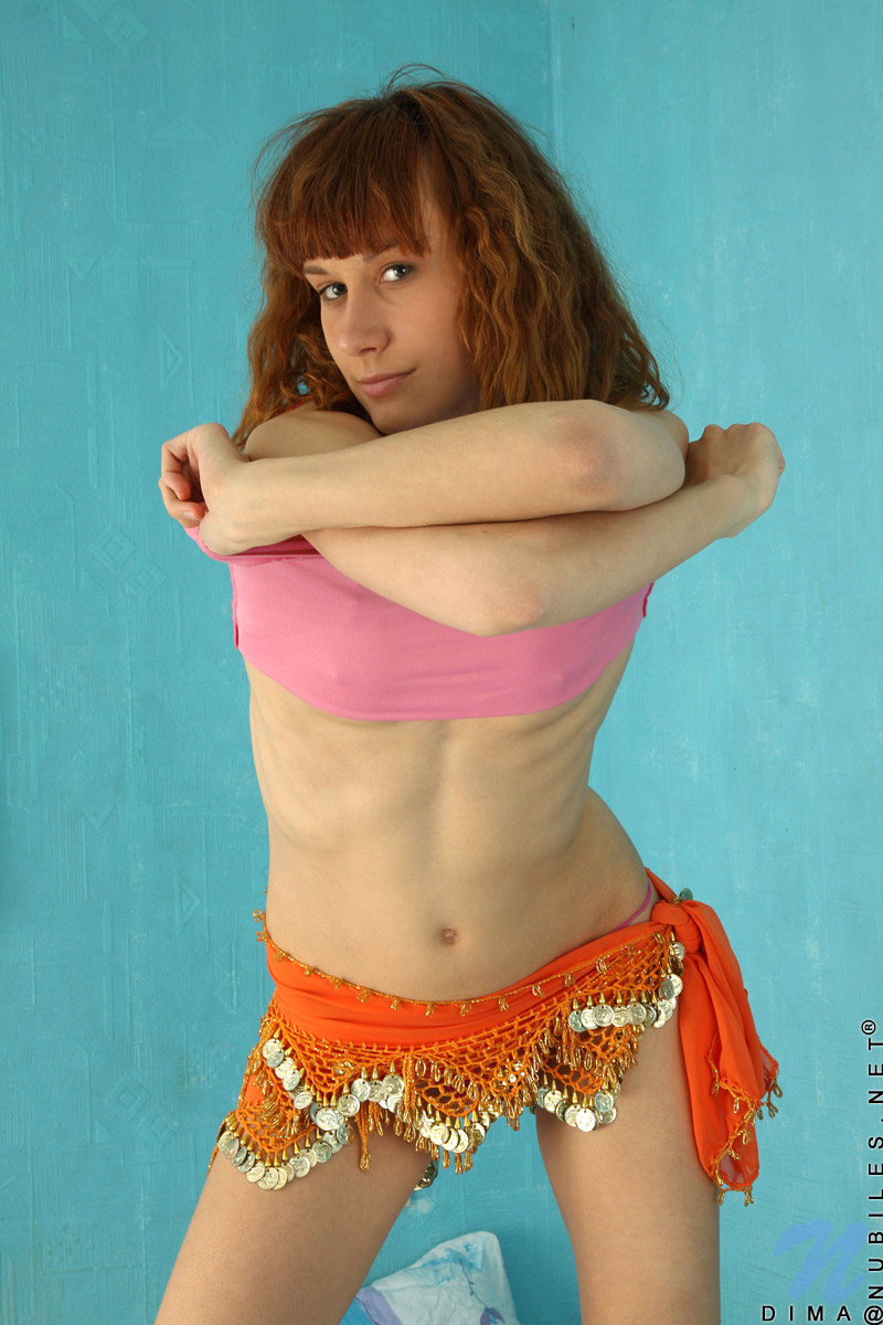 Coed chick Dima slides off her skirt and exposes her hot body on her bed