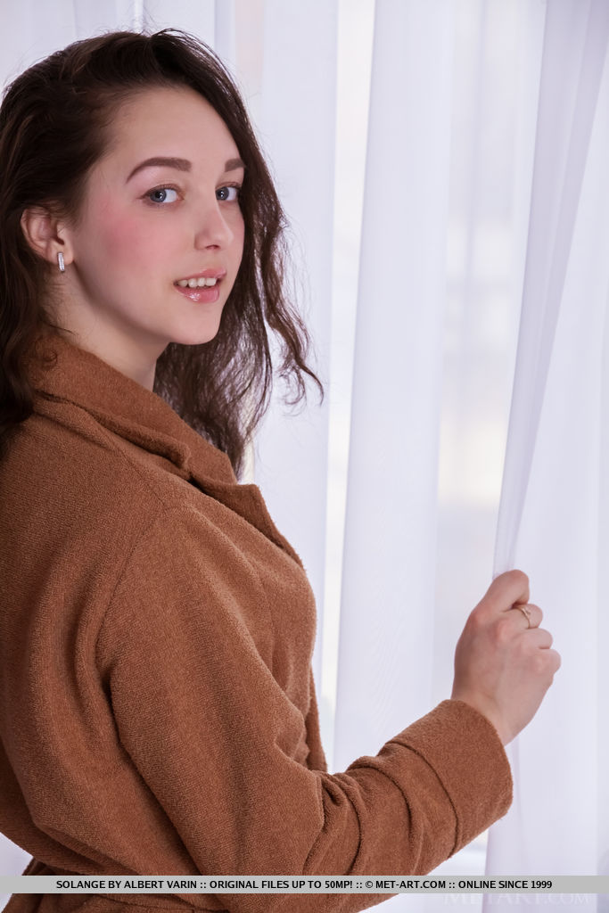 Solange strips on the sofa as she displays her small pussy.