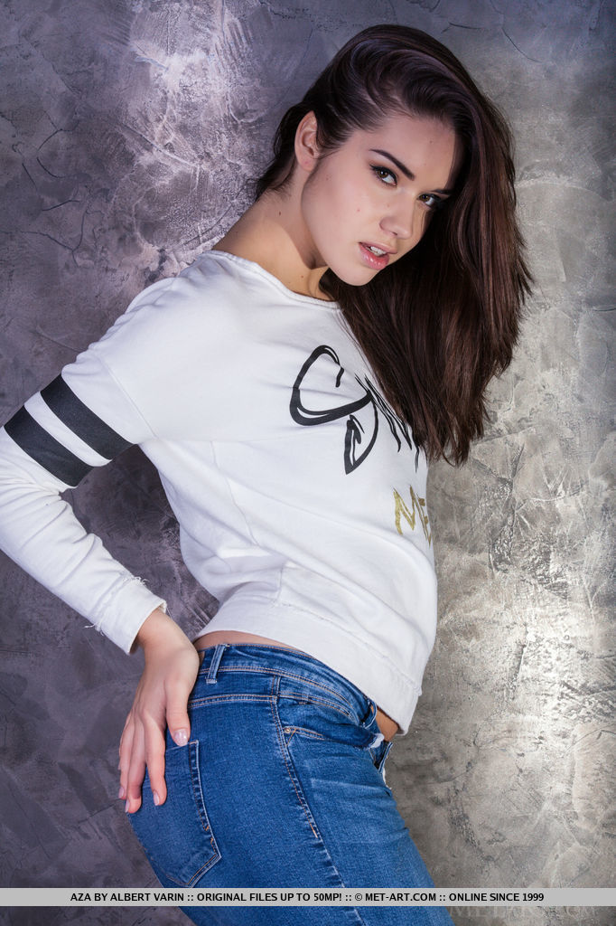 A daring Aza slowly undressing white pullover top and blue denim jeans.