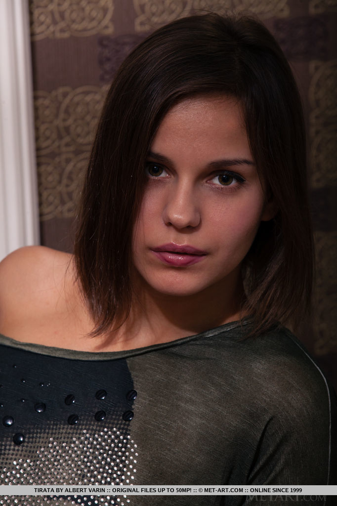 Newcomer Tirata poses on top of the sofa and showcasing her naked, delectable body in black fishnet stockings.