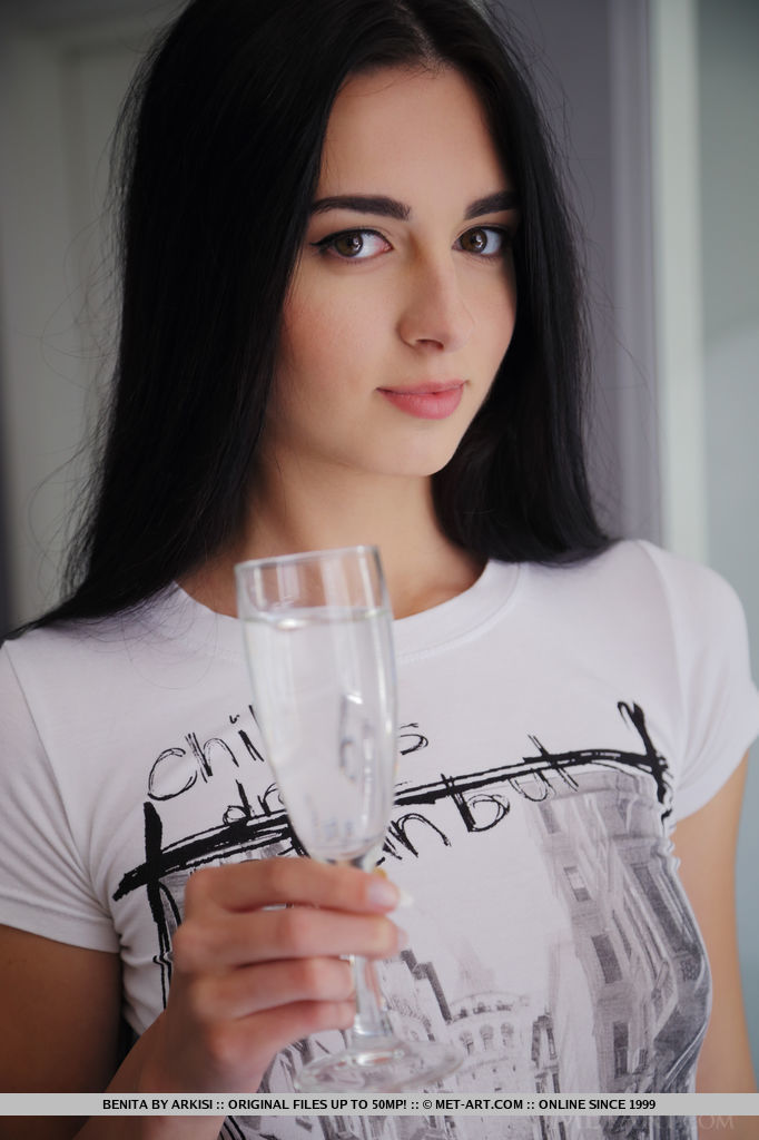 After a glass of sparkling champagne, Benita takes off her t-shirt and spreads her legs wide open to flaunt her exquisite, unshaven pussy.