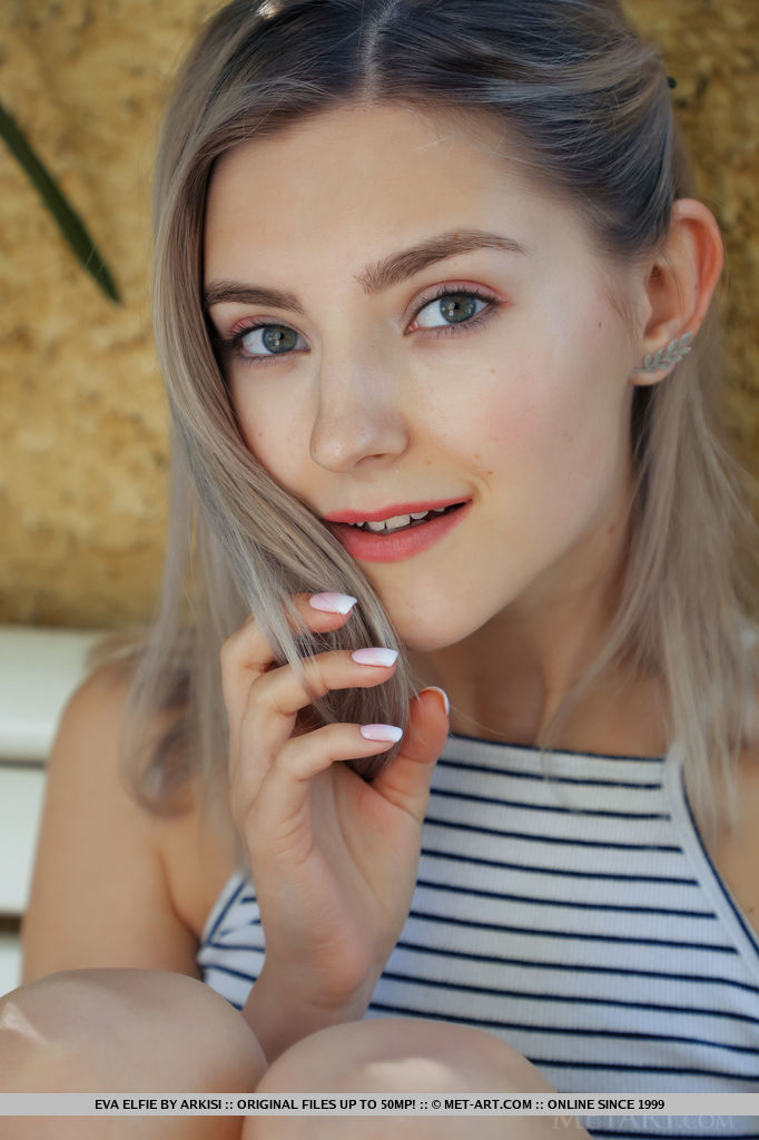 After sweeping leaves, Eva Elfie goes nude on the bench. She gives a close up of her smoothly shaved pussy.