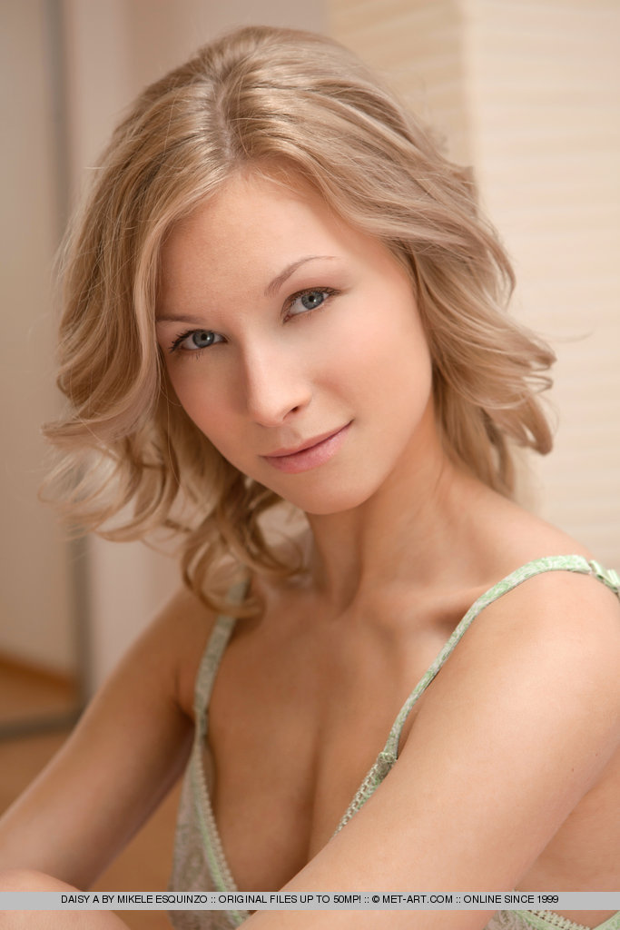 Daisy lays invitingly on the bed, with legs wide open.