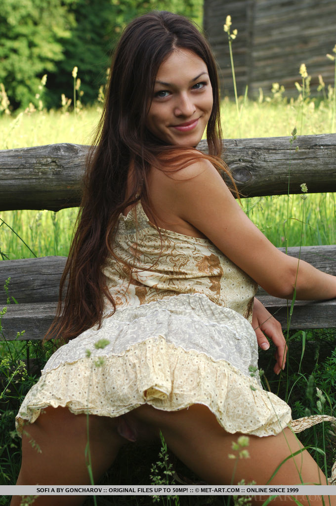 Sofi A teases her amazing breasts out of her little dress in a field of beautiful green grass. 