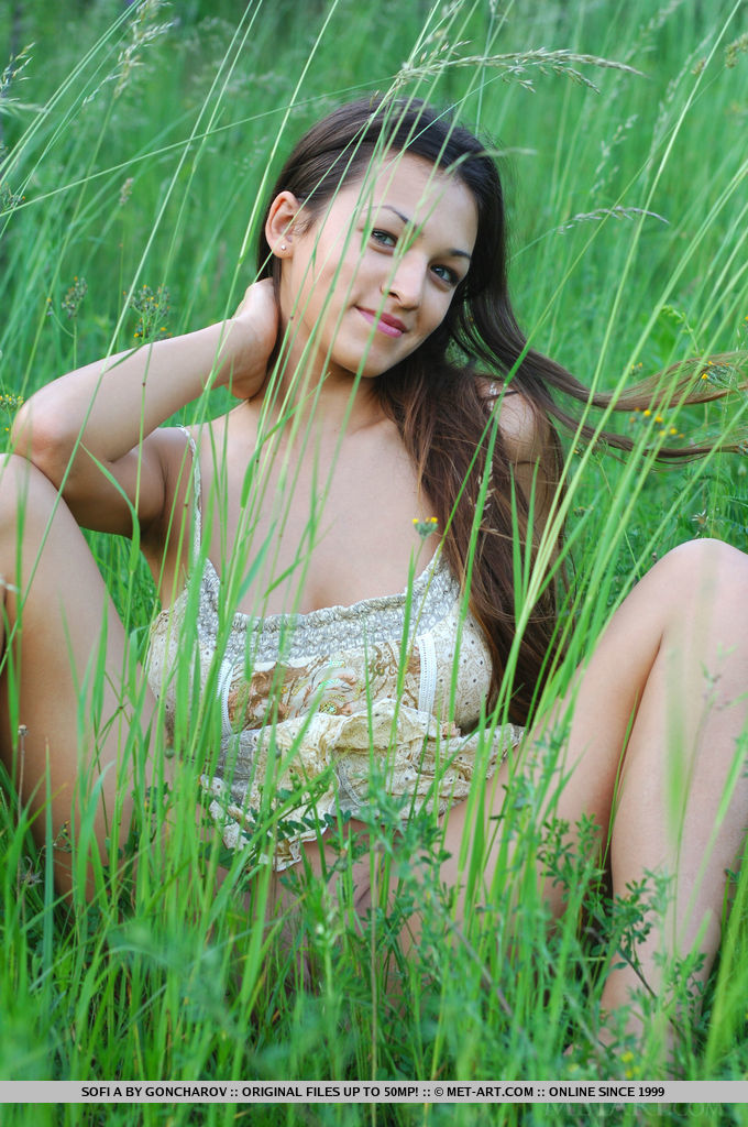 Sofi A teases her amazing breasts out of her little dress in a field of beautiful green grass. 