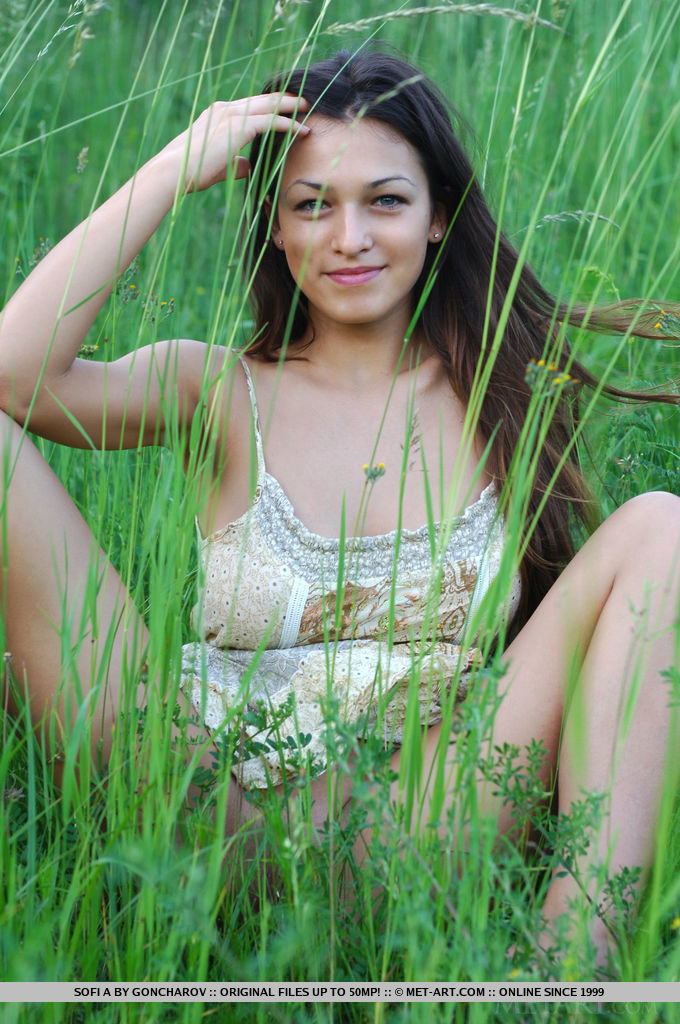 Sofi A teases her amazing breasts out of her little dress in a field of beautiful green grass. 