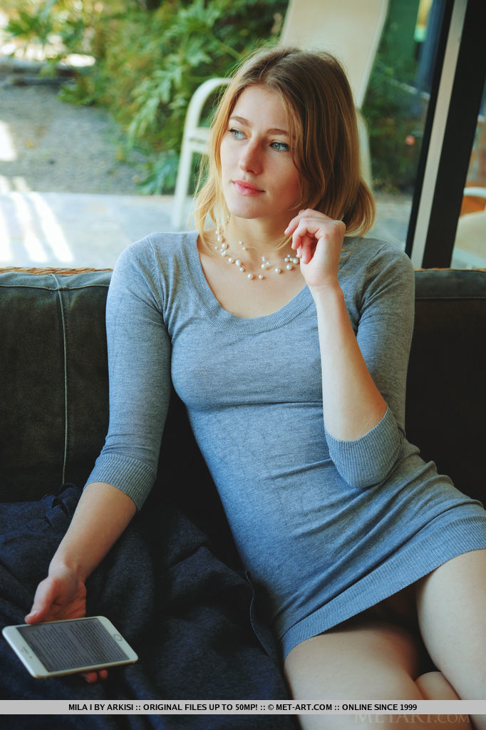 Mila I sensually poses on the couch as she flaunts her delectable pussy.