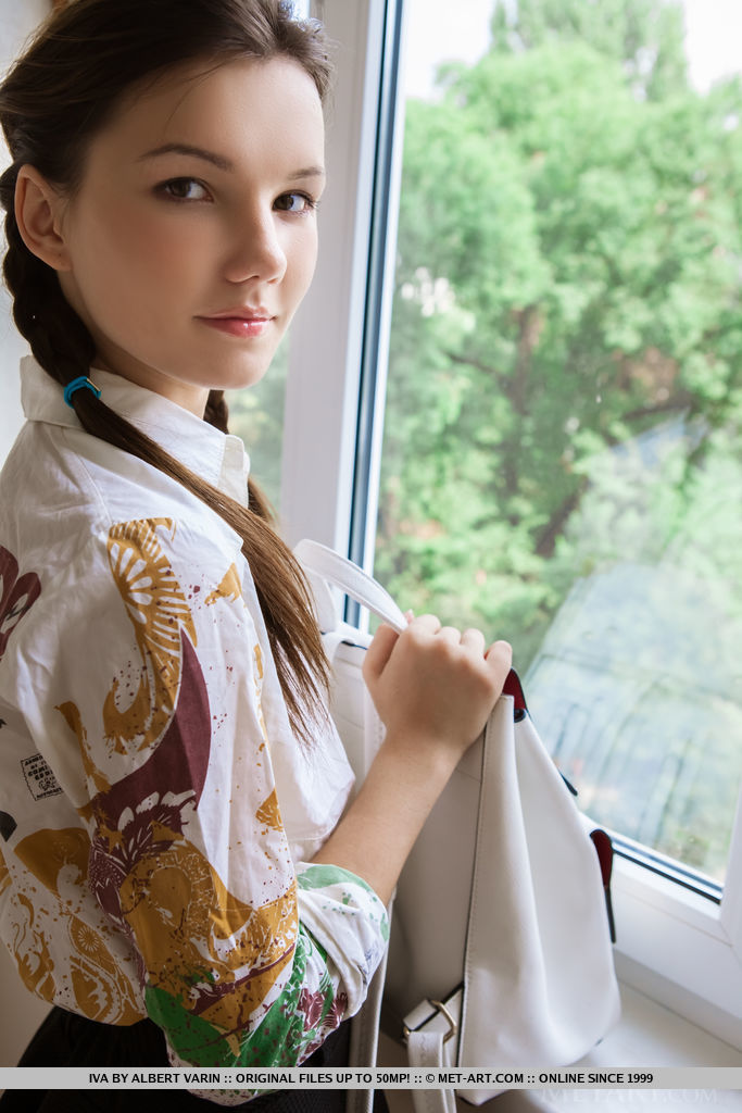 Iva spreads her legs on the chair baring her hairy pussy.