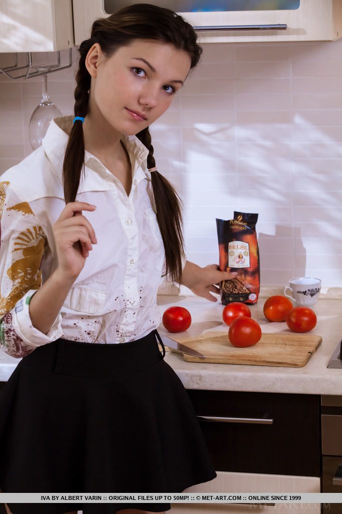 Iva spreads her legs on the chair baring her hairy pussy.