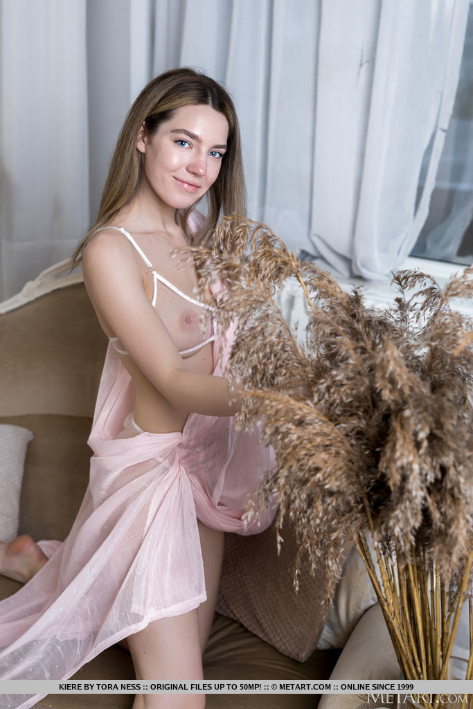 Stunning brunette Kiere is dressed to thrill in sexy lingerie, bending over to reveal the split crotch of her skimpy panties that offers a glimpse of her pussy.