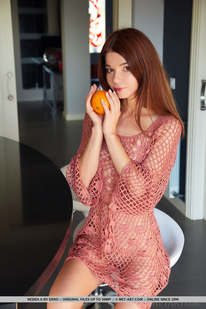Brown-haired Nedda A looks stunning in her mesh dress in the kitchen. She then poses naked on the bar stool and kitchen counter.