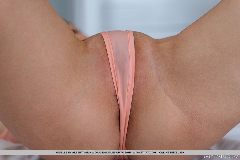 Giselle  looks so hot in her peach tanga body suit which gives a preview of her long slender fit body and trimmed muff.
