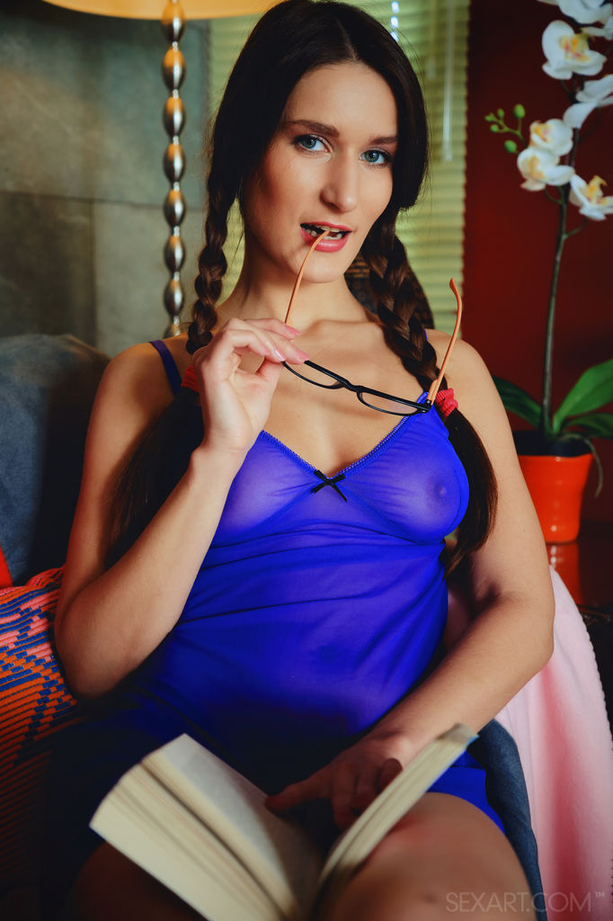 Elina takes a break from reading and starts fingering her pussy