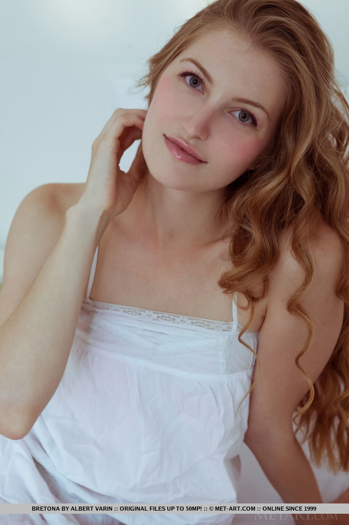 One could easily get hypnotized in Rebecca’s sparkling blue eyes with seductive gaze as she poses without inhibitions on top of the white bed