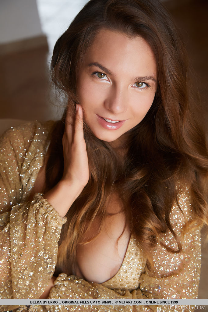 Stunning brunette Belka will captivate you with her flirtatious gaze and provocative body language as she pulls her shimmering gold dress open to bare her perfect breasts. 