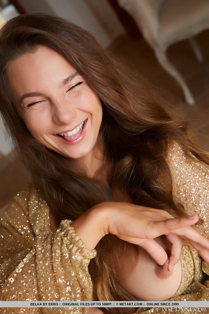 Stunning brunette Belka will captivate you with her flirtatious gaze and provocative body language as she pulls her shimmering gold dress open to bare her perfect breasts. 