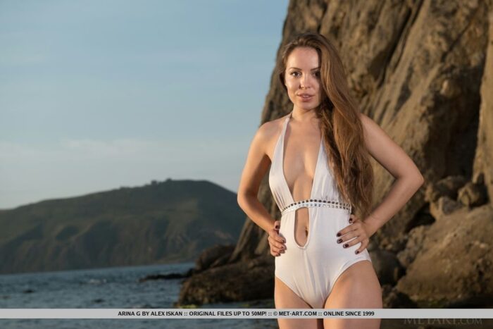 Arina G flaunts her perfect body on the beach in her sexy white swimsuit