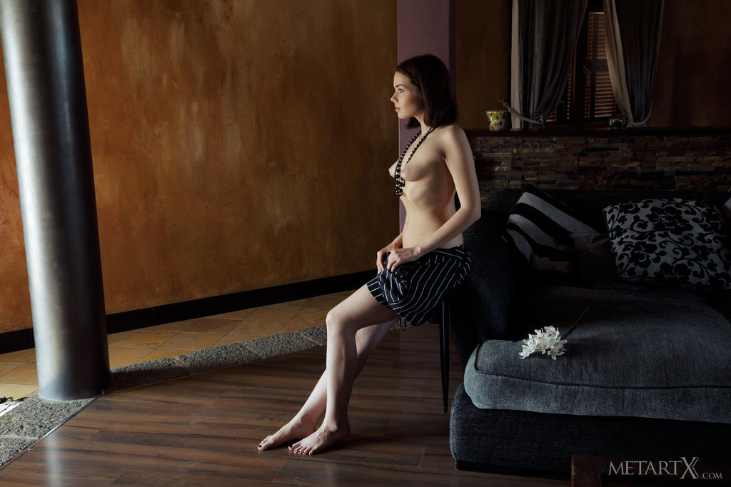 Keira Blue looks sentimental in the living room. She takes off her romper and reveals her puffy nipples and hairy pussy,