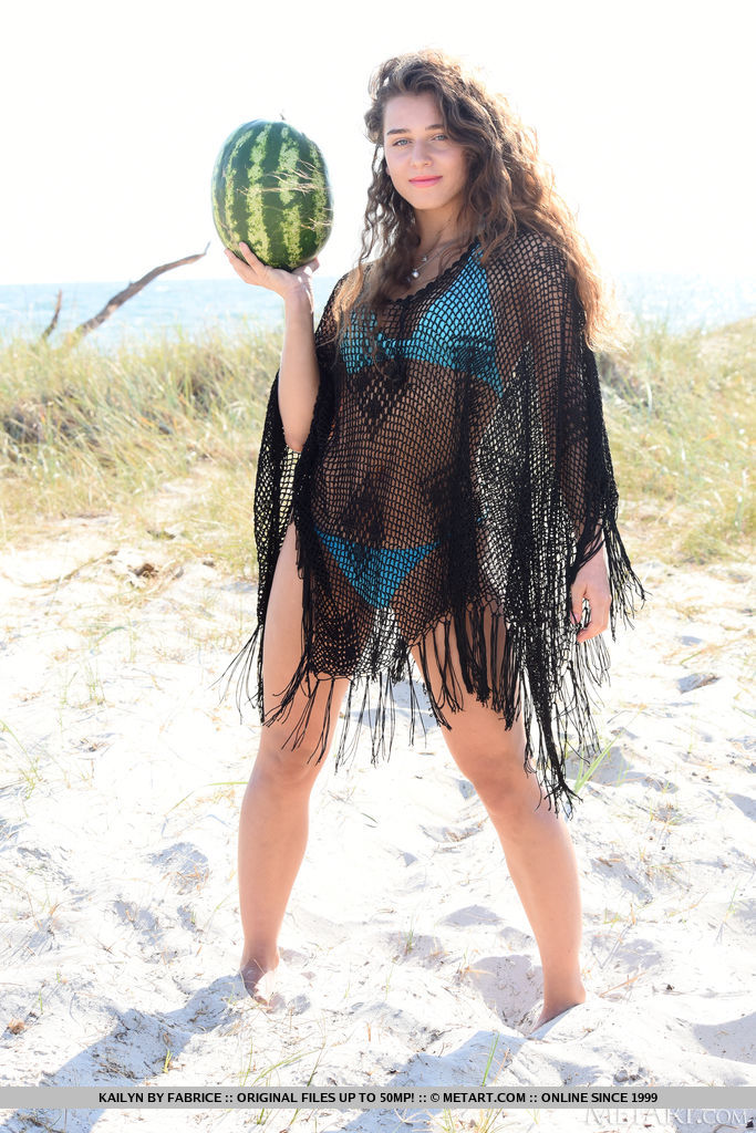 Kailyn enticingly removes her black cover up and blue bikini and exposes her sun-tanned skin and extra juicy melons on the sandy beach.