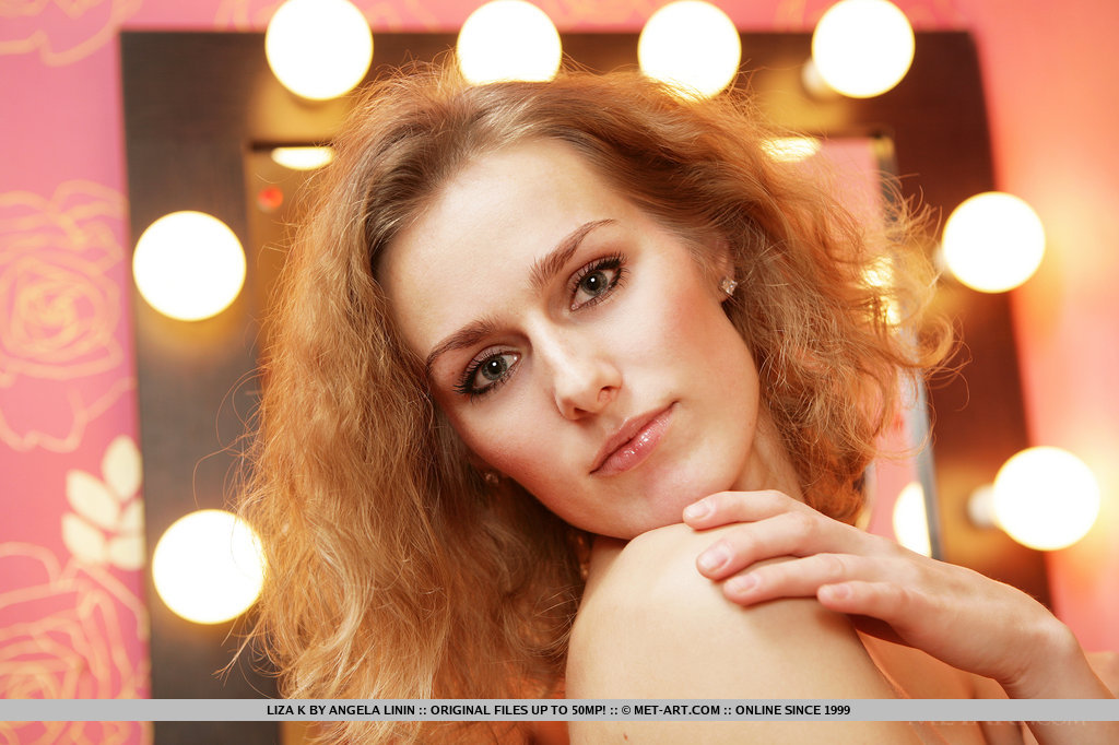 Liza K is an eye candy seated on a chair as she flaunts and strips her red sexy night dress all over the dressing room.