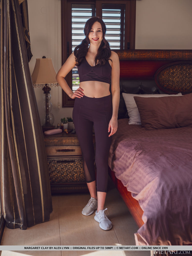 Margaret Clay slips out off her workout clothes and lifts her toes up in the air as she lay don on the bed and gives an open view of her pinkish smooth coochie.