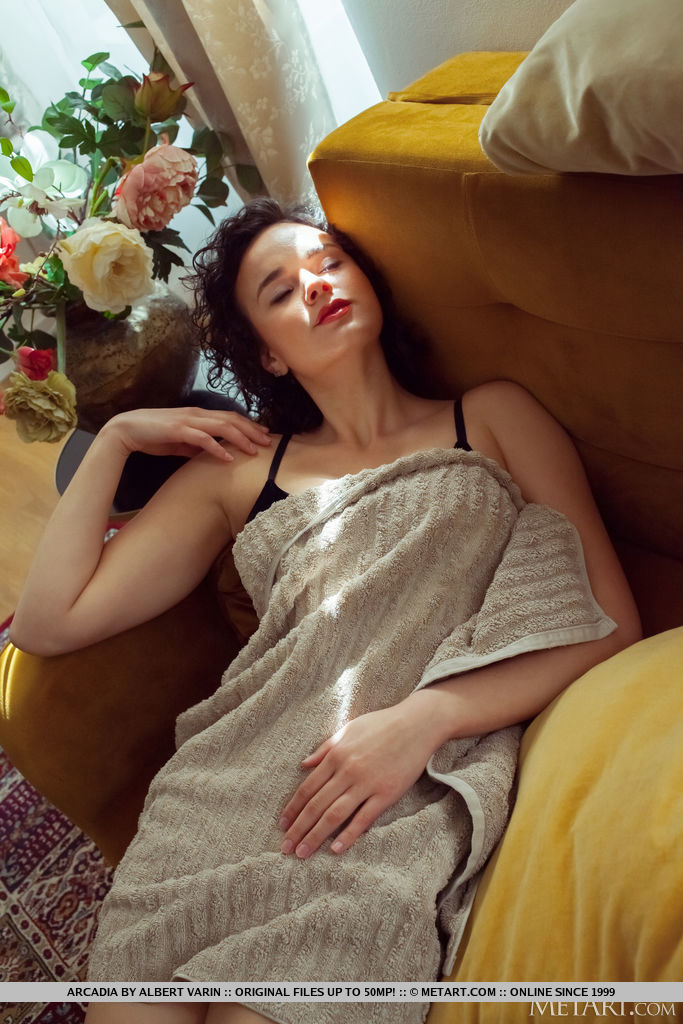 Arcadia unwraps the towel from her sexy body and flashes her huge juicy melons and shaved pussy on the mustard colored sofa.