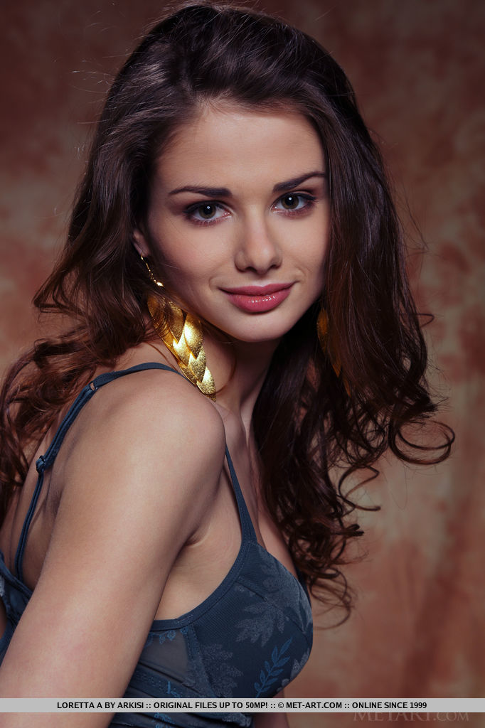 Sultry Loretta A posing confidently in her sheer lingerie dress and string panty as she teases and seduces in front of the camera